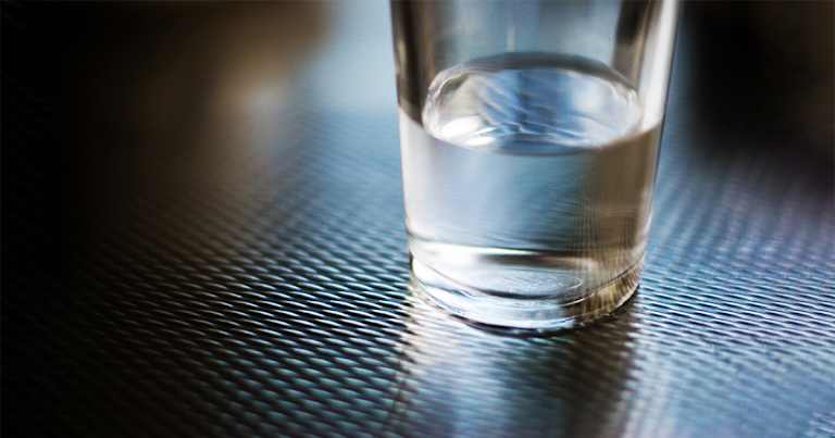 a glass half full of water.