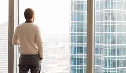 A man looking out of a window.